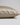 A close-up of a pillowcase in champagne silk, showing its smooth texture and hidden zipper detail, set against a neutral light gray background.