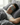 ZILK Deep Restoration Sleep Mask in Dark Gray promotes complete darkness for restful sleep. The user relaxes comfortably in bed.