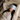 Woman with a light blue ZILK silk sleep mask over her eyes laying in bed with her head on an ivory silk pillowcase. 