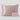 A light pink silk pillowcase displayed next to its matching pink ZILK Sleep box on a light gray background. The box features the brand name 'ZILK' in  Charcoal text.
