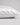 A close-up of a pillowcase in white silk, showing its smooth texture and hidden zipper detail, set against a neutral light gray background.